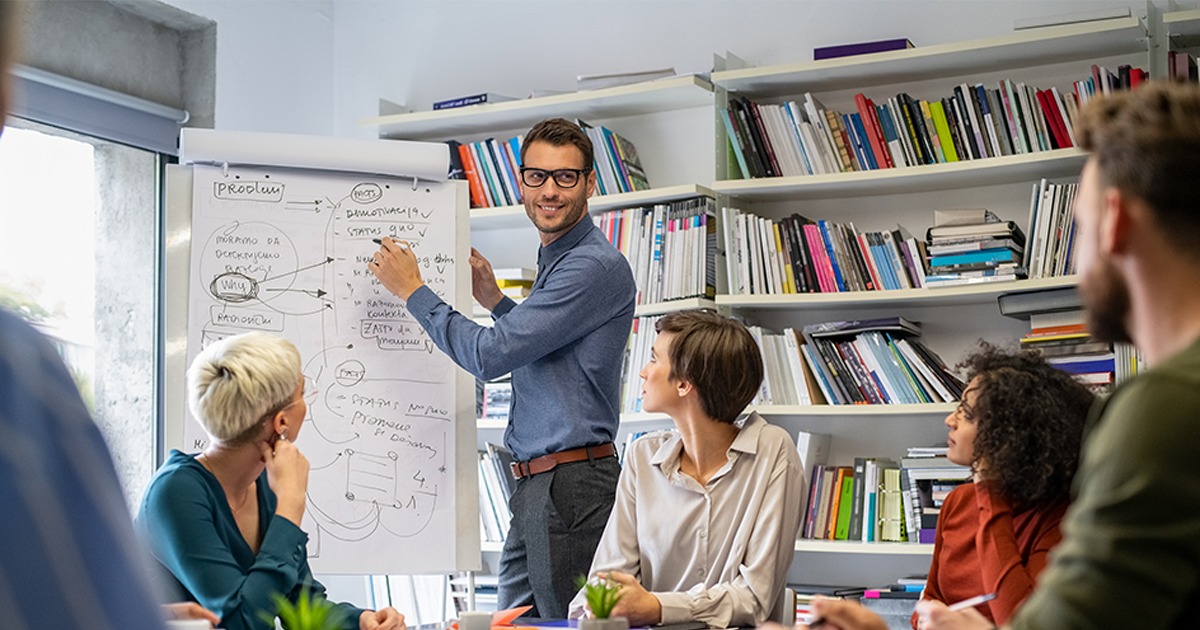 Leader briefing his creative business team with annual goals.
